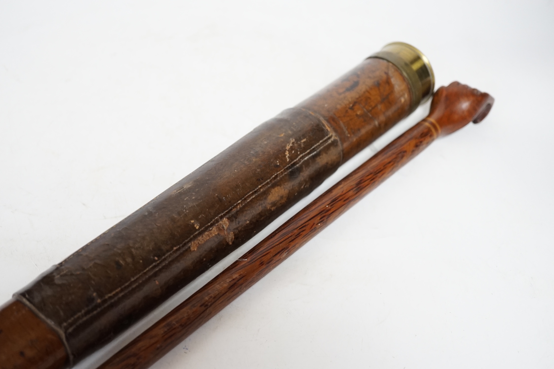 An inscribed cocus wood walking stick with carved handle in the form of a hand, ‘Pitcairn Island’ and a brass mounted two drawer telescope, largest 92cm in length